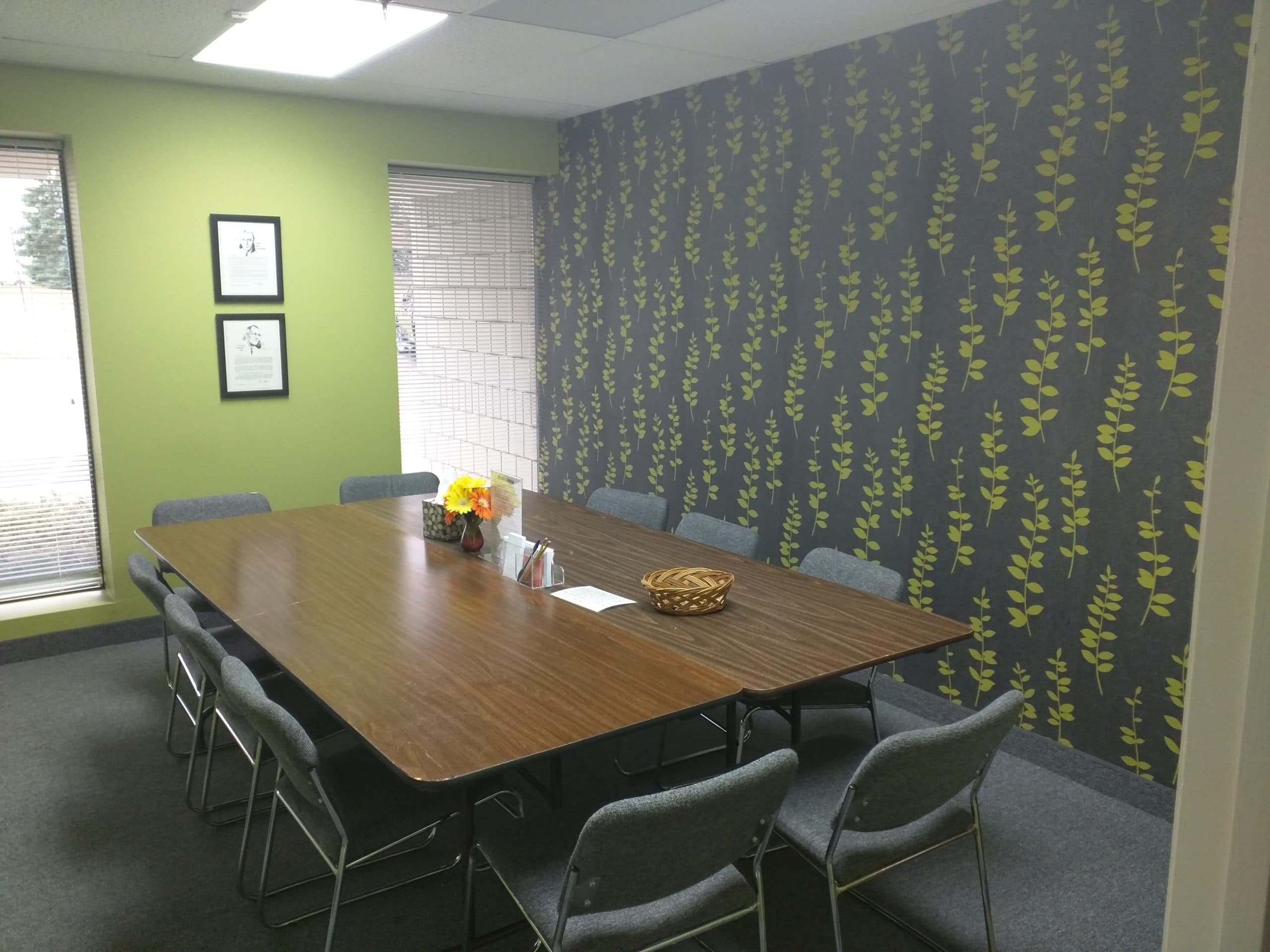 Rectangular conference room with a long table and seating for eight